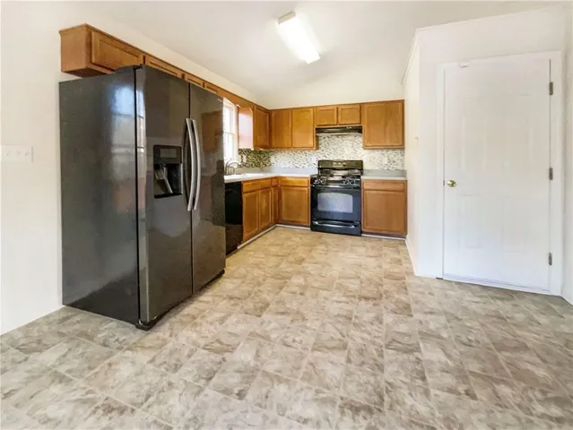 a kitchen with stainless steel appliances a refrigerator and a sink