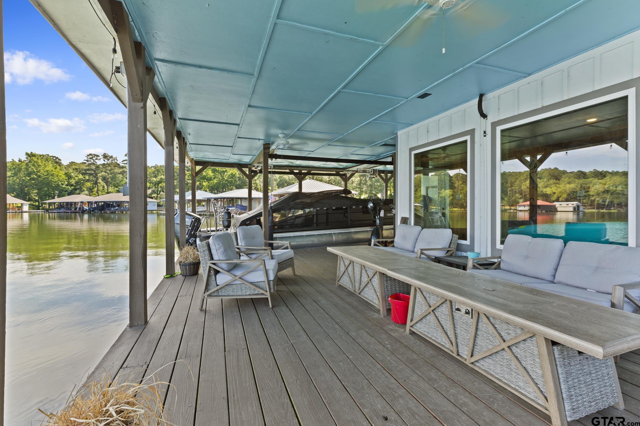 18630 Eastside Road Troup, TX 75789 - Photo 36 of 47 a roof deck with table and chairs and wooden floor