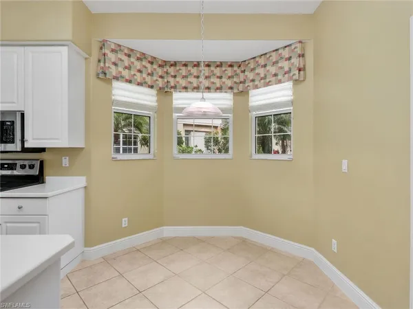 a view of kitchen with windows and furniture
