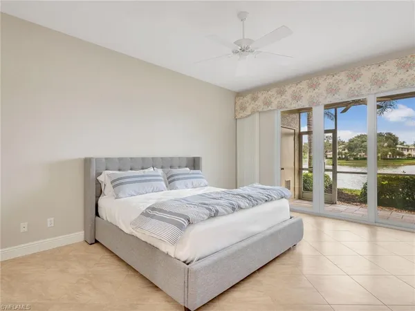 a bedroom with a large bed and a chandelier