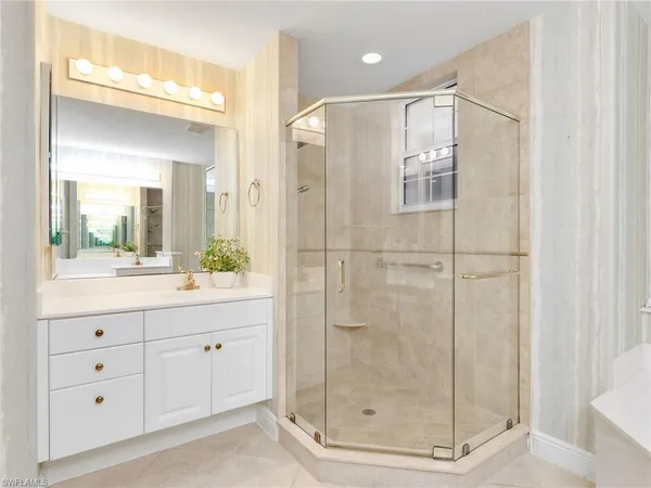 a bathroom with a shower sink and mirror