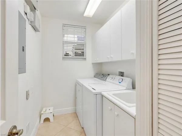 a utility room with a sink washer and dryer