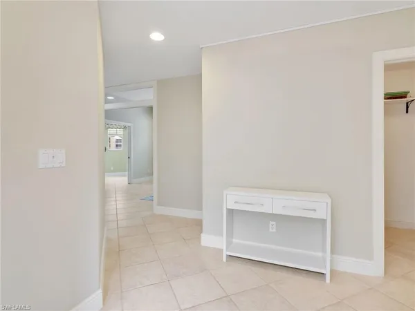 a view of an empty room and a bathroom