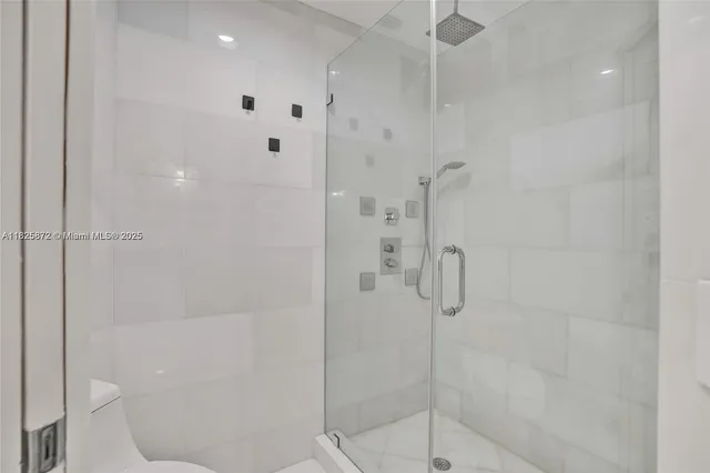 a bathroom with a shower sink and mirror