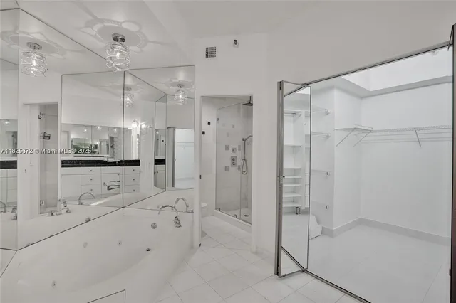 a bathroom with a granite countertop sink a mirror and a shower