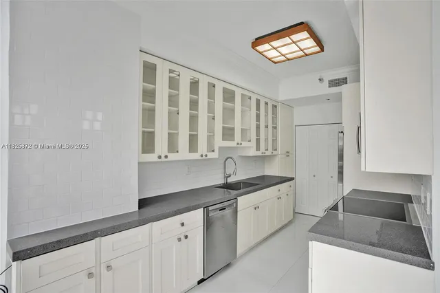 a kitchen with stainless steel appliances granite countertop a sink and a granite counter tops