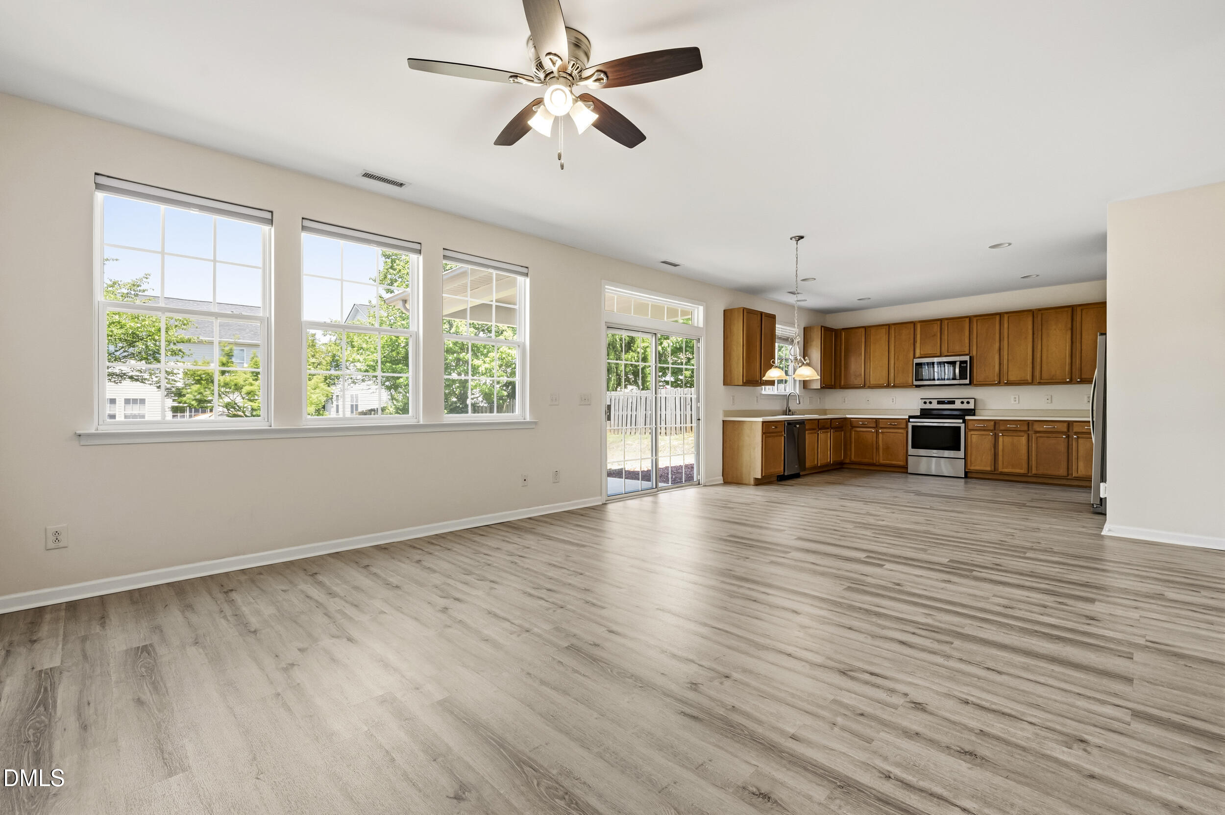 112 Ryder Cup Circle Raleigh, NC 27603 - Photo 5 of 45 a view of a living room a kitchen island wooden floor and a window