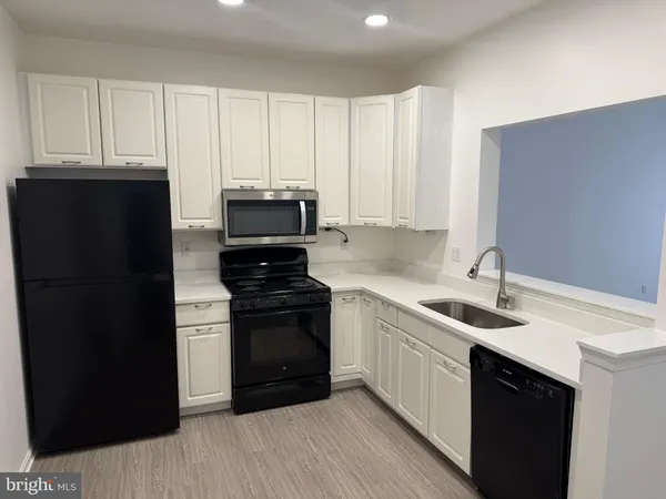 a kitchen with a sink and stainless steel appliances