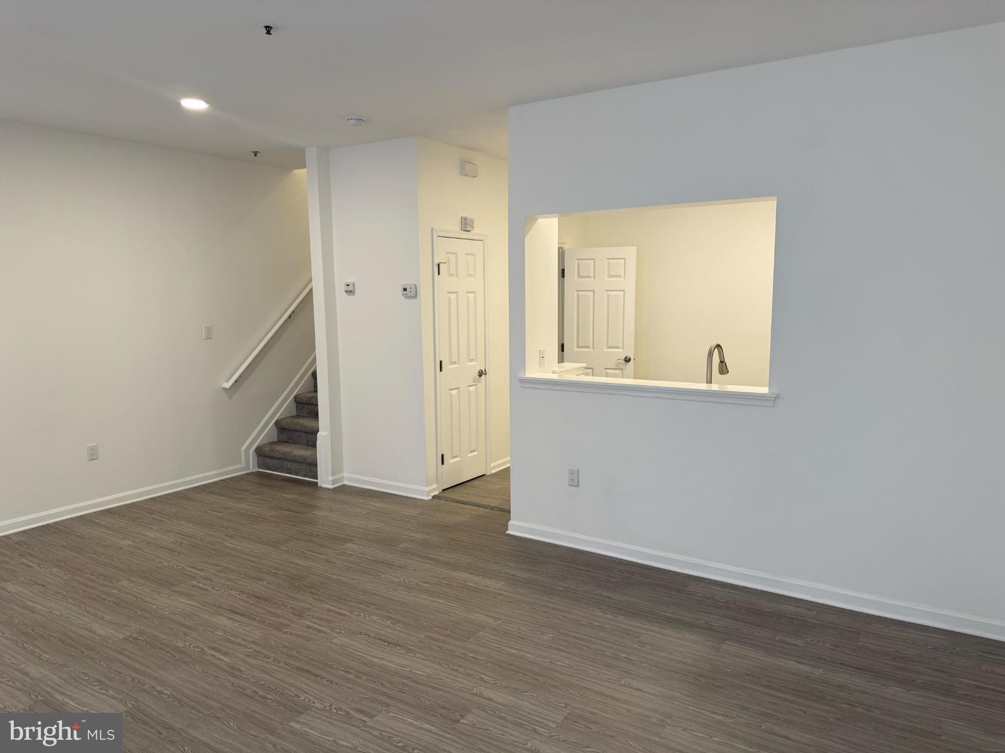 2014 Crosbyside Court Odenton, MD 21113 - Photo 7 of 21 an empty room with wooden floor and cabinet