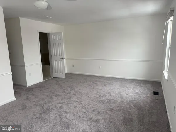 an empty room with a empty space and windows