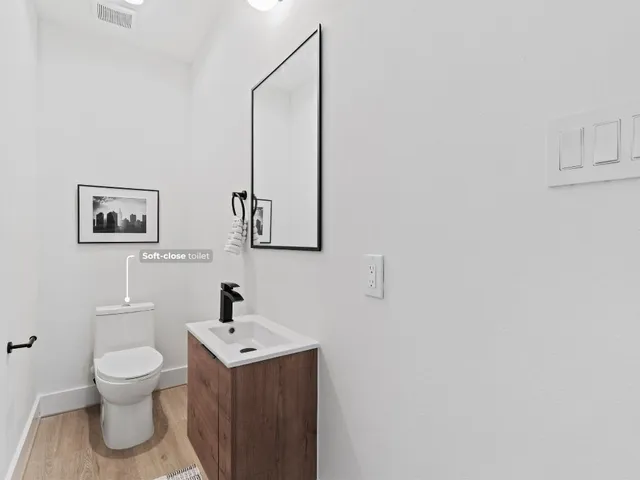 a white toilet sitting next to a bathroom sink