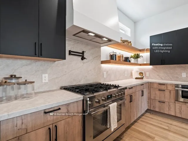 a kitchen with stainless steel appliances granite countertop a stove and a sink