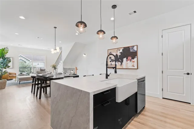 a large kitchen with a table and chairs