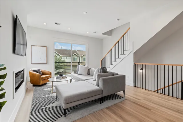 a bedroom with furniture and a large window