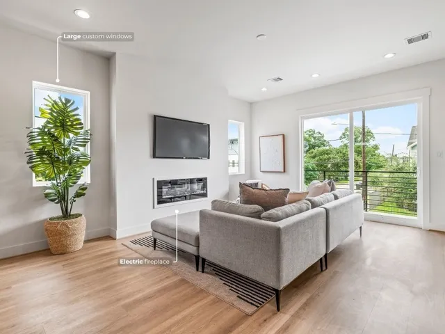 a living room with fireplace furniture and a flat screen tv