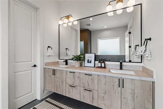 a bathroom with a double vanity sink and mirror