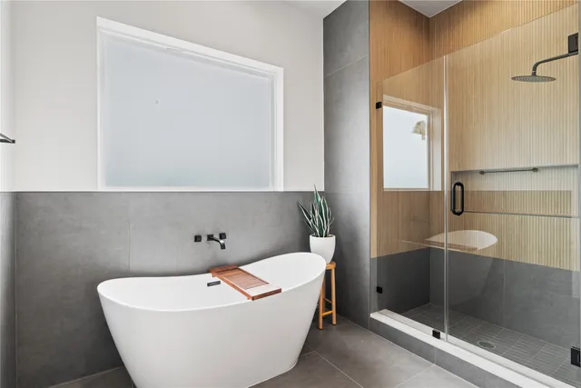 a bath tub sitting next to a white toilet