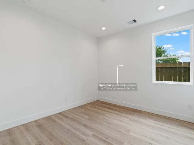 a view of a room with wooden floor and window
