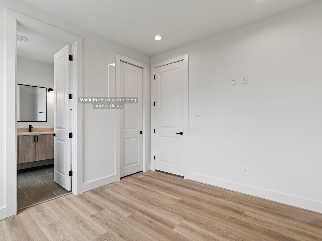 4436 Oats Street Houston, TX 77020 - Photo 6 of 37 a view of a hallway with a bedroom and wooden floor