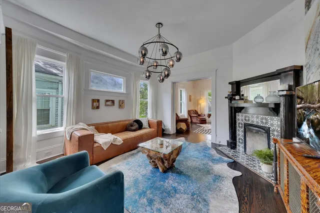 a living room with furniture and a chandelier