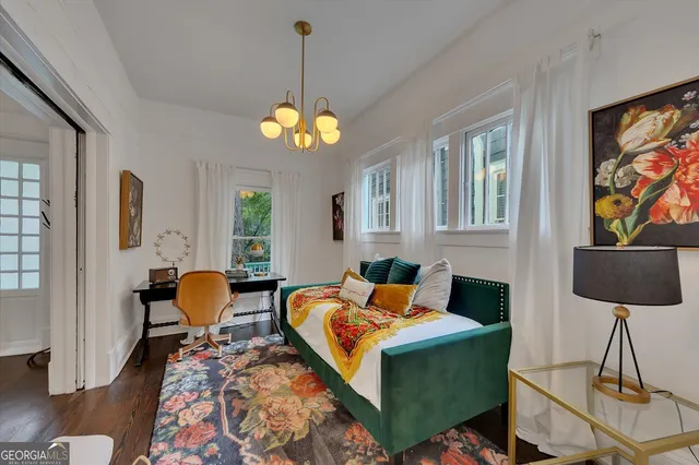 a living room with furniture a chandelier and a flat screen tv