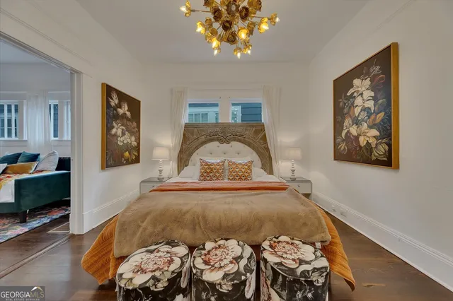 a bedroom with a bed and a chandelier