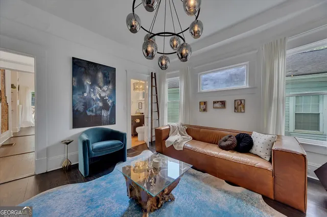 a living room with furniture and a chandelier