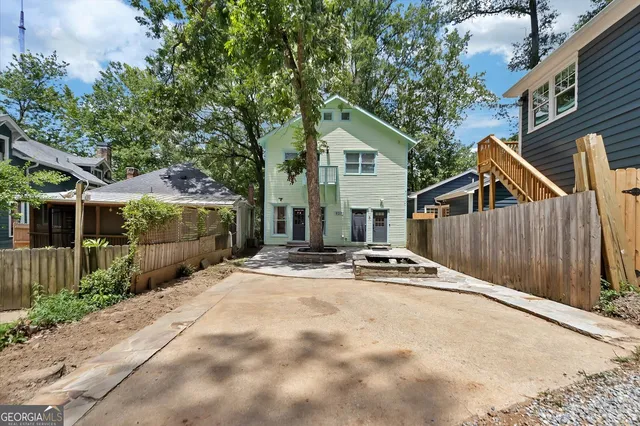 a view of house with street and trees in the background