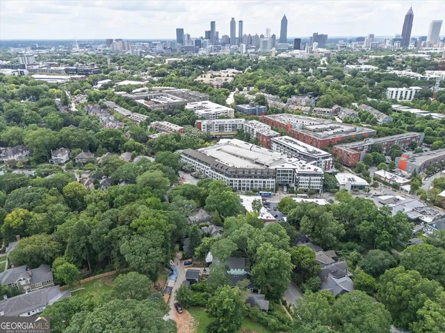 an aerial view of residential houses with city view