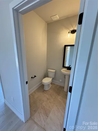 a bathroom with a toilet and a mirror