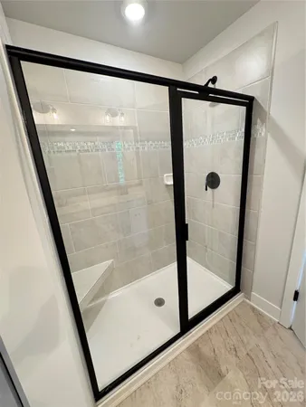 a bathroom with a glass shower door