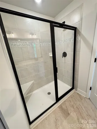 a bathroom with a glass shower door