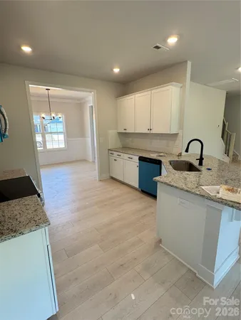 a kitchen with stainless steel appliances granite countertop a sink stove and cabinets