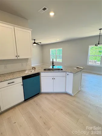 a kitchen with a sink cabinets and appliances