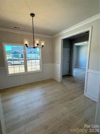 a view of empty room with window and entryway