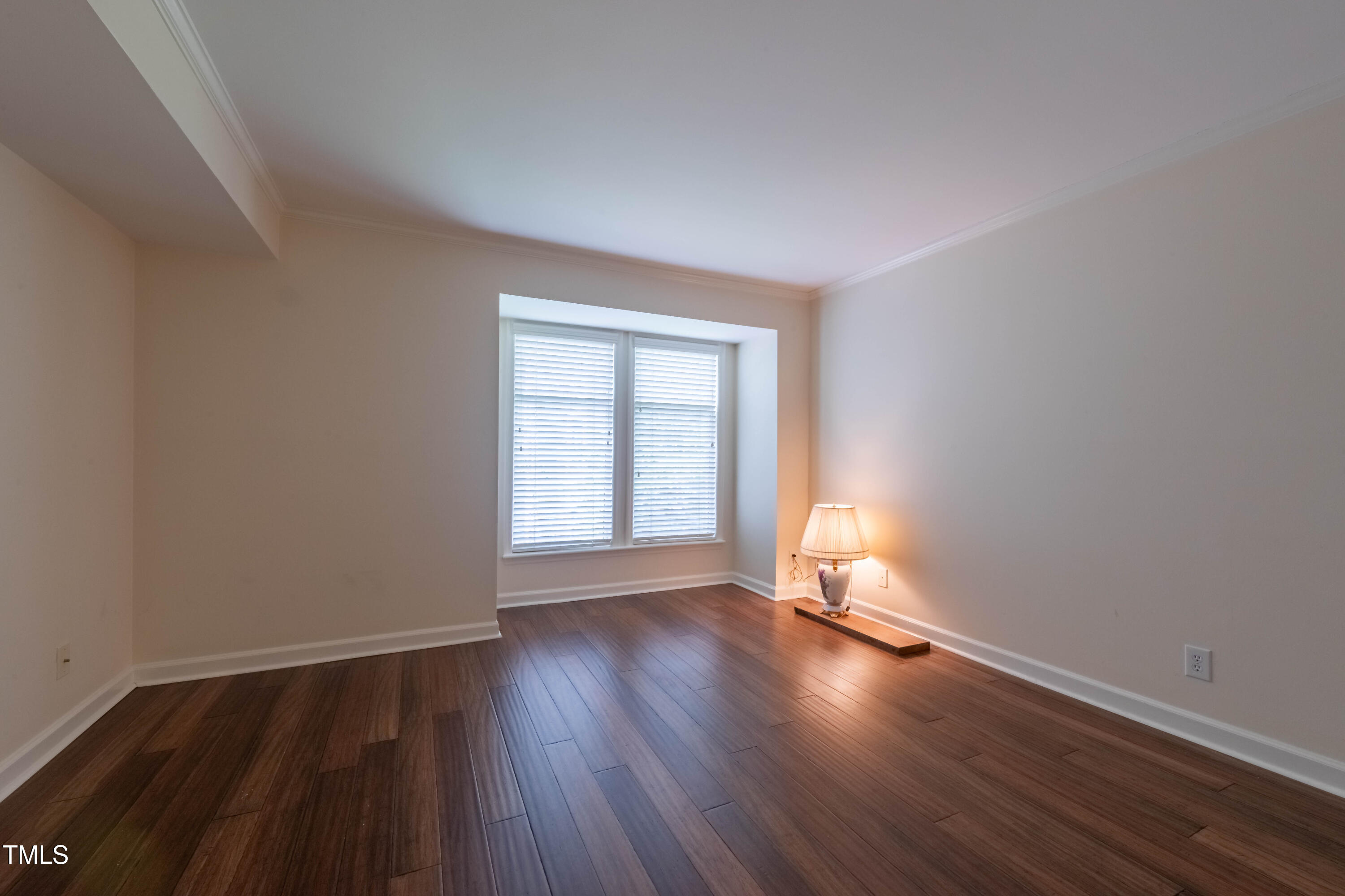 1211 Westview Lane, Unit 201 Raleigh, NC 27605 - Photo 15 of 40 an empty room with wooden floor and windows