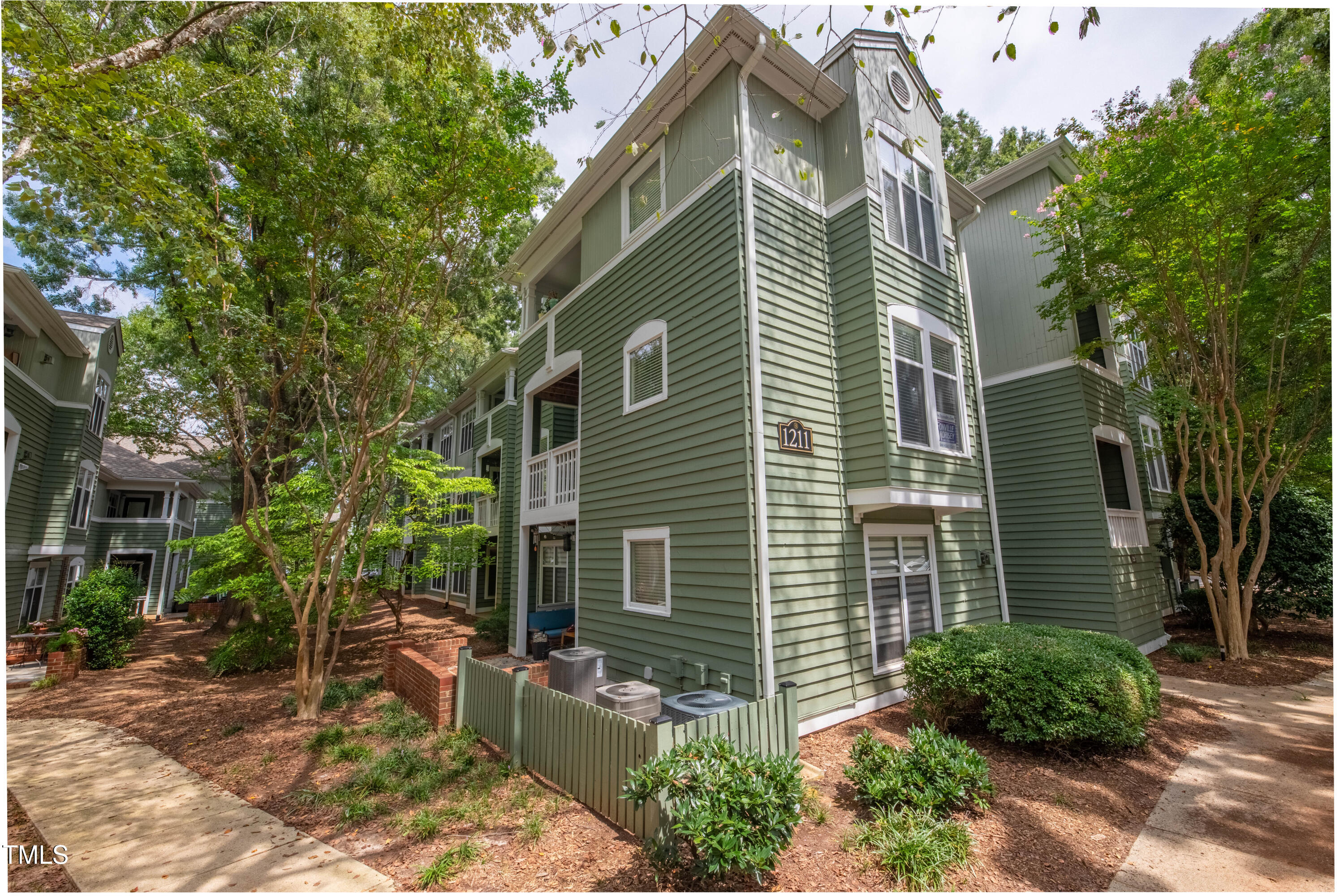 1211 Westview Lane, Unit 201 Raleigh, NC 27605 - Photo 24 of 40 a view of a house with a yard and sitting area