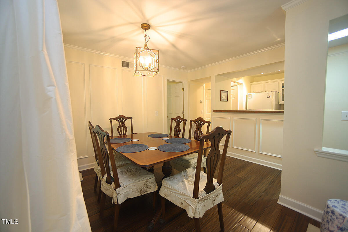 1211 Westview Lane, Unit 201 Raleigh, NC 27605 - Photo 36 of 40 a view of a dining room with furniture and wooden floor