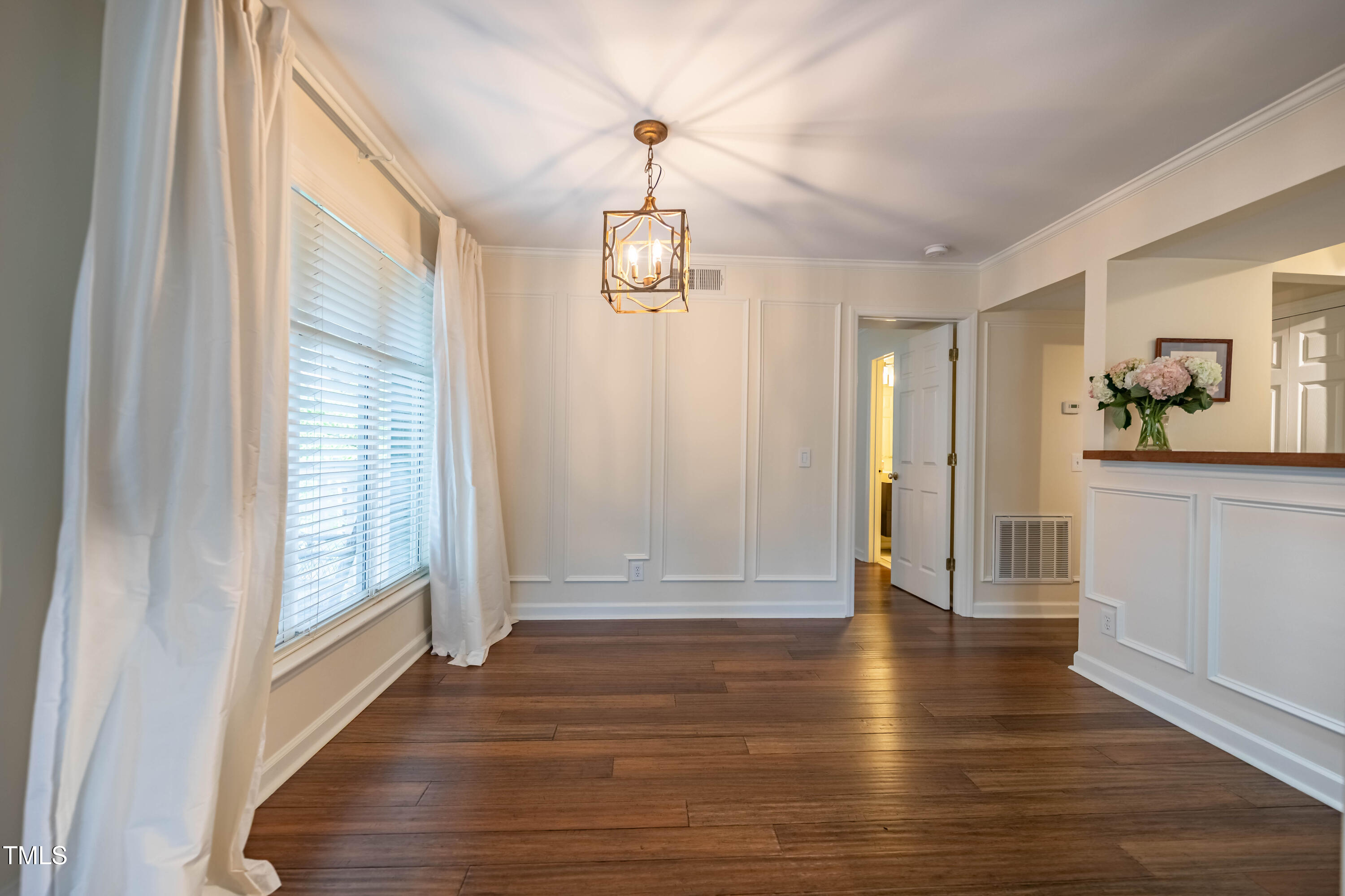 1211 Westview Lane, Unit 201 Raleigh, NC 27605 - Photo 8 of 40 a view of a hallway with wooden floor and windows