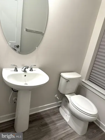a white toilet sitting next to a bathroom sink