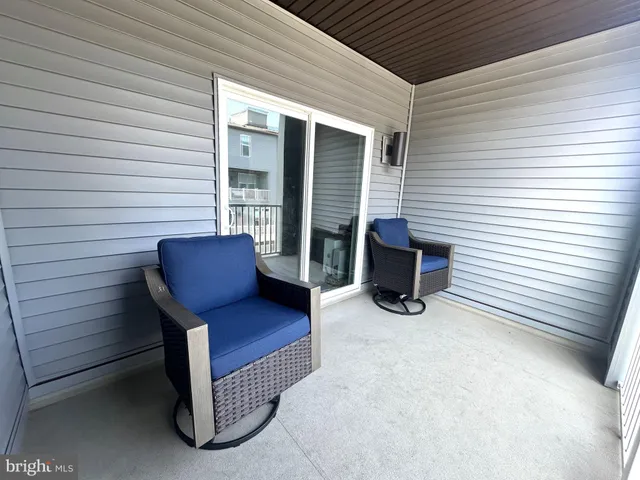 a view of two chairs in the balcony