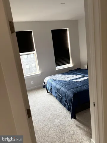 a bedroom with a bed and a television