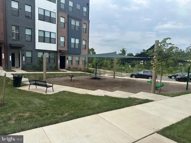 a park with lots of tall buildings and a yard