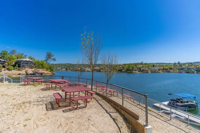 a view of a lake with a table and chairs