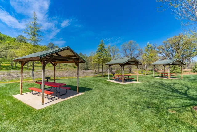 a backyard of a house with table and chairs