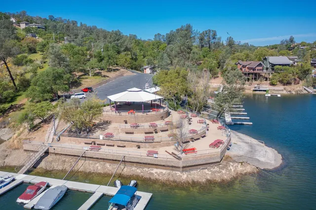 a white house with a yard and lake view
