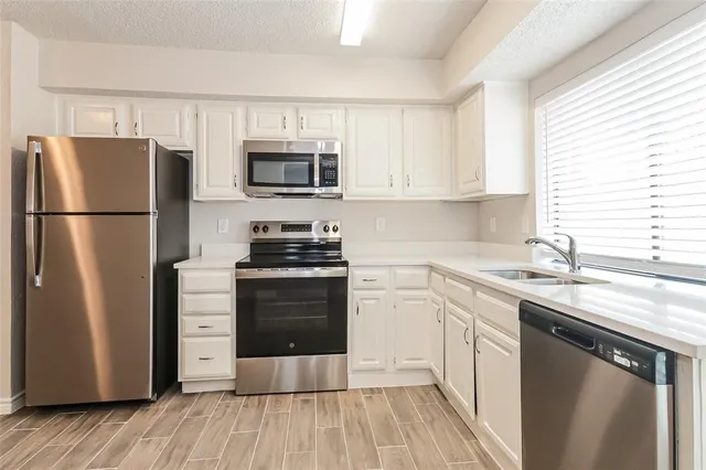 a kitchen with a refrigerator stove and sink
