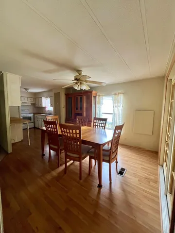 a view of a dining room with furniture and wooden floor