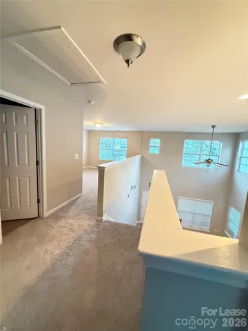 a view of a room with wooden floor and windows