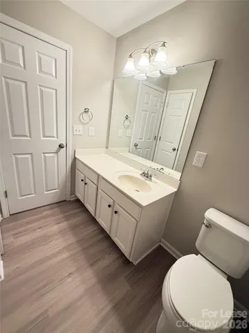 a bathroom with a double vanity sink mirror and toilet